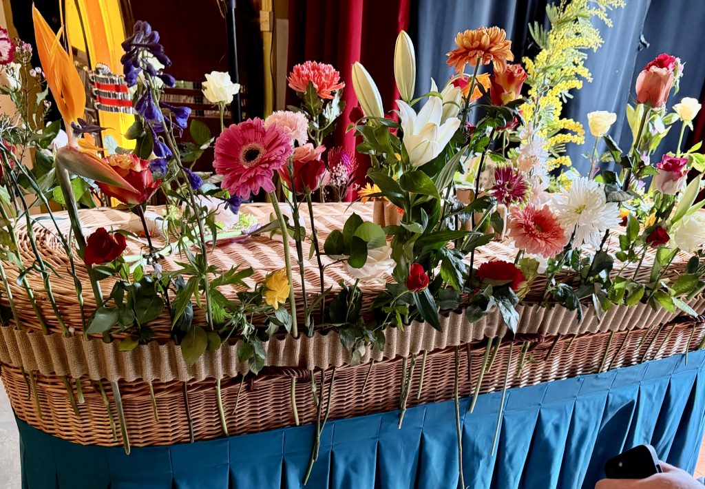 Bloemenband om mand Memoriam Uitvaart